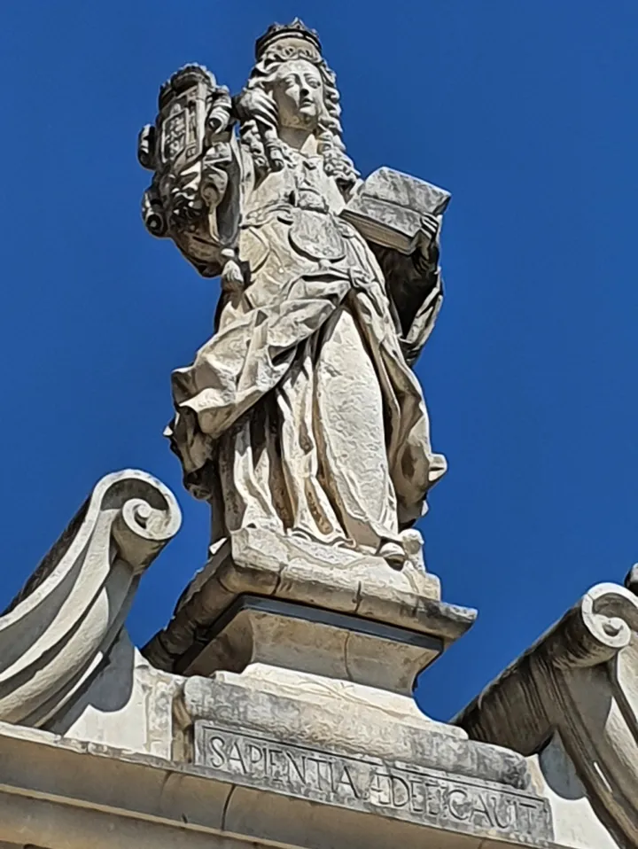 Statue of Minerva crowning the arch of the Minerva Stairs at the University of Coimbra